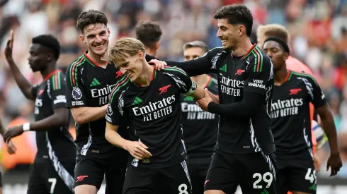 Martin Odegaard of Arsenal celebrates scoring his team's second goal with teammates during the Premier League match between Southampton FC and Arsenal FC at St Mary's Stadium on May 25, 2025 in Southampton, England.