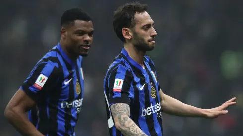 Hakan Calhanoglu of Inter Milan celebrates with his team-mate Denzel Dumfries after scoring against Lazio.