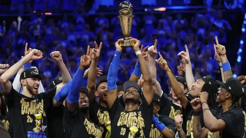 Shai Gilgeous-Alexander #2 of the Oklahoma City Thunder celebrates with the Bill Russell NBA Finals Most Valuable Player trophy after defeating the Indiana Pacers.