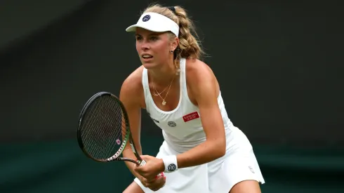Magdalena Frech of Poland looks on against Ons Jabeur of Tunisia in the Women's Singles first round match during day two of The Championships Wimbledon 2023.