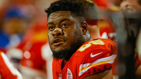 Trey Smith #65 of the Kansas City Chiefs sits on the Chiefs bench during the game against the Denver Broncos at Arrowhead Stadium on December 5, 2021.