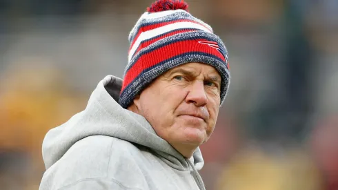 Head coach of the New England Patriots, Bill Belichick, stands on the field during warm-ups prior to the NFL game against the Green Bay Packers at Lambeau Field on November 30, 2014 in Green Bay, Wisconsin.