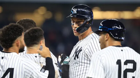 Aaron Judge #99 of the New York Yankees waits for a video replay call with teammates after hitting a walk-off sacrifice fly ball during the tenth inning against the Seattle Mariners.
