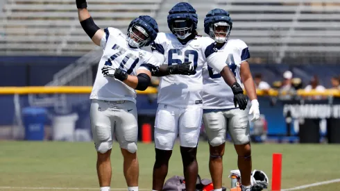 Guard Zack Martin #70 offensive tackle Tyler Guyton #60 and offensive tackle Earl Bostick Jr. #64 of the Dallas Cowboys stretch during training camp on July 30, 2024.