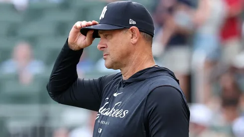 Manager Aaron Boone #17 of the New York Yankees steps out to the field for the National Anthem.