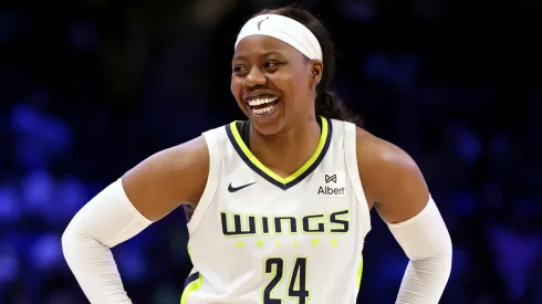 Arike Ogunbowale #24 of the Dallas Wings smiles while on the court during the fourth quarter against the Golden State Valkyries at College Park Center on June 17, 2025.