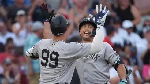 Giancarlo Stanton #27 of the New York Yankees celebrates solo home run by Aaron Judge #99 of the New York Yankees.