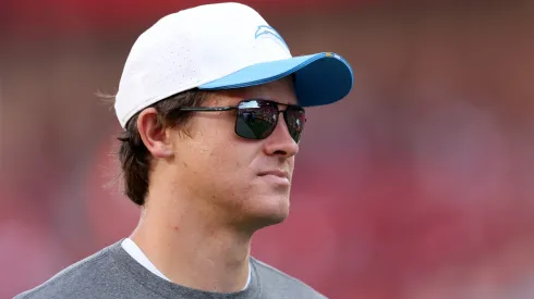 Justin Herbert #10 of the Los Angeles Chargers stands on the field.