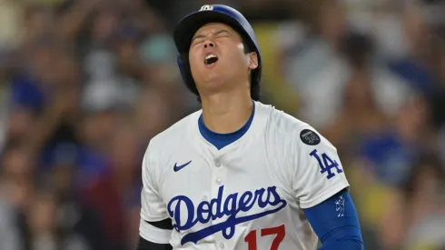 Shohei Ohtani #17 of the Los Angeles Dodgers reacts after fouling a ball off his foot.