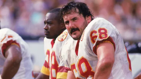 Russ Grimm #68 of the Washington Redskins sits on the bench during a 1987 season game.