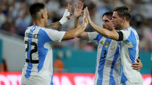 Giovani Lo Celso celebrates with teammates his goal for Argentina against Venezuela.