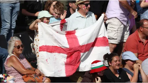 Fans hold a large English flag