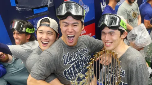 Shohei Ohtani #17, Yoshinobu Yamamoto #18, and Roki Sasaki #11 of the Los Angeles Dodgers celebrate.