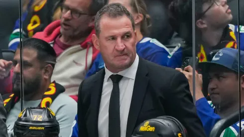 Vancouver Canucks head coach Adam Foote looks on during an NHL game.