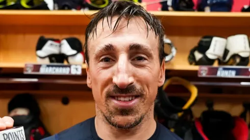 Brad Marchand poses for a picture after recording his 1,000th NHL point