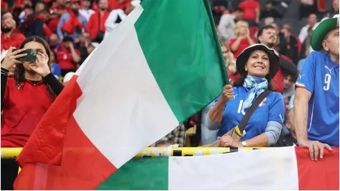 A fan waves the national flag of Italy