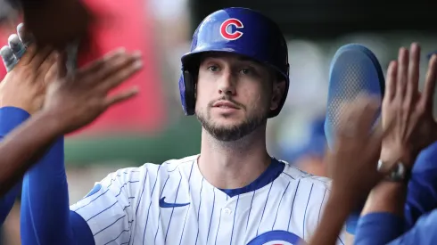 Kyle Tucker #30 with the Chicago Cubs high-fives teammates in the dugout.