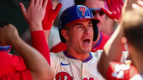 J.T. Realmuto #10 of the Philadelphia Phillies celebrates with teammates in the dugout.