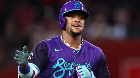 Ketel Marte #4 of the Diamondbacks gestures while running the bases after hitting a solo home run.