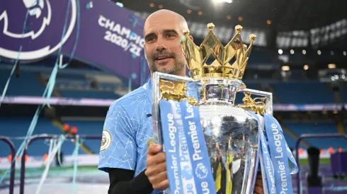 MANCHESTER, ENGLAND - MAY 23: Pep Guardiola, Manager of Manchester City celebrates with the Premier League Trophy as Manchester City are presented with the Trophy as they win the league following the Premier League match between Manchester City and Everton at Etihad Stadium on May 23, 2021 in Manchester, England. A limited number of fans will be allowed into Premier League stadiums as Coronavirus restrictions begin to ease in the UK. (Photo by Michael Regan/Getty Images)