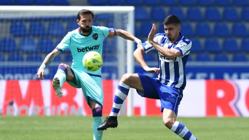 VITORIA-GASTEIZ, SPAIN - MAY 08: Roger of Levante UD battles for possession with Rodrigo Battaglia of Deportivo Alaves during the La Liga Santander match between Deportivo Alavés and Levante UD at Estadio de Mendizorroza on May 08, 2021 in Vitoria-Gasteiz, Spain. Sporting stadiums around Spain remain under strict restrictions due to the Coronavirus Pandemic as Government social distancing laws prohibit fans inside venues resulting in games being played behind closed doors. (Photo by Juan Manuel Serrano Arce/Getty Images)