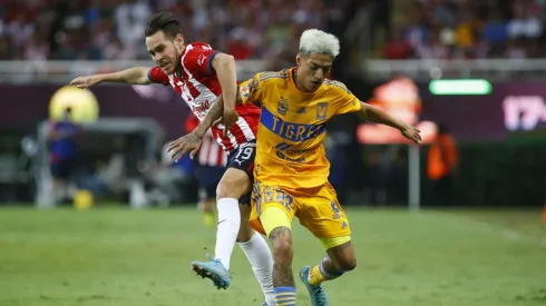 ZAPOPAN, MEXICO – SEPTEMBER 13:  Jesús Angulo of Chivas fights for the ball with Raymundo Fulgencio of Tigres during the 9th round match between Chivas and Tigres UANL as part of the Torneo Apertura 2022 Liga MX at Akron Stadium on September 13, 2022 in Zapopan, Mexico. (Photo by Refugio Ruiz/Getty Images)
