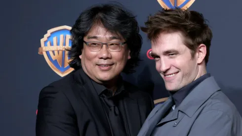LAS VEGAS, NEVADA - APRIL 09: (L-R) Bong Joon-ho and Robert Pattinson attend the Warner Bros. Pictures Presentation during CinemaCon 2024 at The Colosseum at Caesars Palace on April 09, 2024 in Las Vegas, Nevada. (Photo by Gabe Ginsberg/Getty Images)