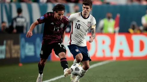 Jun 6, 2021; Denver, Colorado, USA; Mexico midfielder Diego Lainez (14) and United States forward Christian Pulisic (10) battle for the ball in extra time during the 2021 CONCACAF Nations League Finals soccer series final match at Empower Field at Mile High. Mandatory Credit: Isaiah J. Downing-USA TODAY Sports