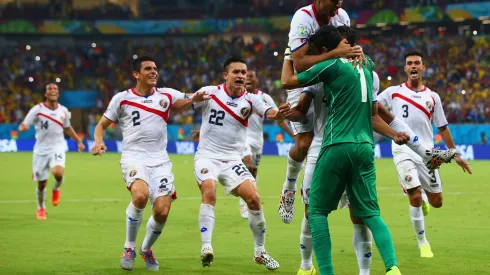 RECIFE, BRAZIL – JUNE 29: Keylor Navas of Costa Rica is swarmed by teammates in celebration after defeating Greece in a penalty shootout during the 2014 FIFA World Cup Brazil Round of 16 match between Costa Rica and Greece at Arena Pernambuco on June 29, 2014 in Recife, Brazil.  (Photo by Paul Gilham/Getty Images)