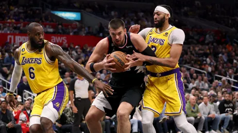 LOS ANGELES, CALIFORNIA - APRIL 05: Ivica Zubac #40 of the LA Clippers grabs a rebound between LeBron James #6 and Anthony Davis #3 of the Los Angeles Lakers during a 125-118 Clippers win at Crypto.com Arena on April 05, 2023 in Los Angeles, California. NOTE TO USER: User expressly acknowledges and agrees that, by downloading and or using this photograph, User is consenting to the terms and conditions of the Getty Images License Agreement. (Photo by Harry How/Getty Images)