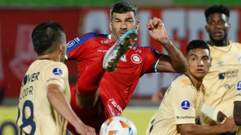 Gigliotti pelea el balón ante los jugadores de Universidad Católica.