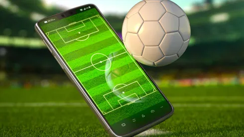 Mobile phone and soccer ball. Football app video game on smartphone and betting online concept. Mobile phone and soccer ball. Football app video game on smartphone and betting sport online concept. 3d illustration LicenseRF 20577687 Copyright: xZoonar.com/MaksymxYemelyanovx 20577687