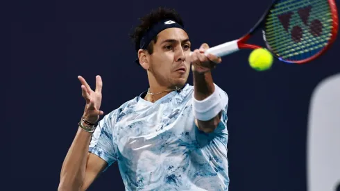 Alejandro Tabilo returns a shot against Casper Ruud at 2025 Miami Open