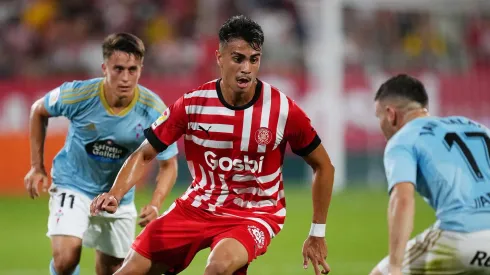 GIRONA, SPAIN – AUGUST 26: Reinier Jesus of Girona FC is put under pressure by Franco Cervi and Javi Galan of RC Celta during the LaLiga Santander match between Girona FC and RC Celta at Montilivi Stadium on August 26, 2022 in Girona, Spain. (Photo by Alex Caparros/Getty Images)