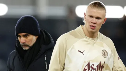 Erling Haaland of Manchester City looks on alongside Pep Guardiola, (Photo by Richard Heathcote/Getty Images)