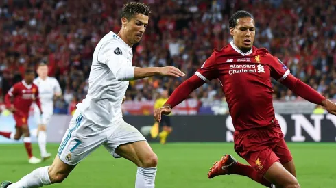 Cristiano Ronaldo of Real Madrid CF competes for Virgil van Dijk .  (Photo by David Ramos/Getty Images)