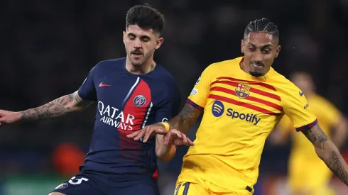 Nuno Mendes of Paris Saint-Germain and Raphinha of FC Barcelona . (Photo by Alex Pantling/Getty Images)