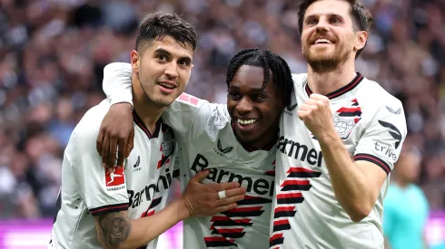 FRANKFURT AM MAIN, GERMANY – MAY 05: Jeremie Frimpong of Bayer Leverkusen celebrates scoring his team's fourth goal with teammates Exequiel Palacios and Jonas Hofmann during the Bundesliga match between Eintracht Frankfurt and Bayer 04 Leverkusen at Deutsche Bank Park on May 05, 2024 in Frankfurt am Main, Germany. (Photo by Alex Grimm/Getty Images)