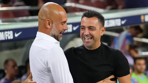 Pep Guardiola,  and Xavi, Head coach of FC Barcelona  (Photo by Alex Caparros/Getty Images)
