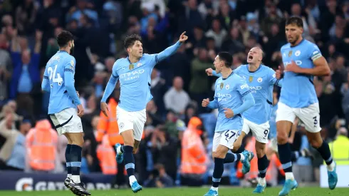 MANCHESTER, ENGLAND - SEPTEMBER 22: John Stones of Manchester City celebrates scoring his team's second goal with teammates during the Premier League match between Manchester City FC and Arsenal FC at Etihad Stadium on September 22, 2024 in Manchester, England. (Photo by Carl Recine/Getty Images)