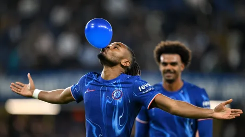 LONDON, ENGLAND – SEPTEMBER 24: Christopher Nkunku of Chelsea celebrates scoring his team's fifth goal, and completing his hattrick by blowing up a ballon during the Carabao Cup Third Round match between Chelsea and Barrow at Stamford Bridge on September 24, 2024 in London, England. (Photo by Mike Hewitt/Getty Images)
