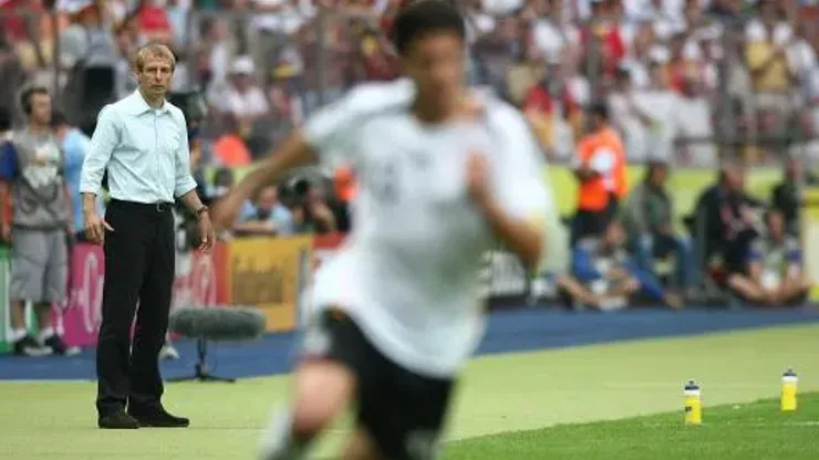 Jurgen Klinsmann, Germany coach looks on as Michael Ballack attacks
