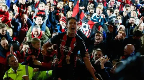 BOURNEMOUTH, ENGLAND - APRIL 27: Captain Tommy Elphick of Bournemouth celebrates victory as fans invade the pitch after the Sky Bet Championship match between AFC Bournemouth and Bolton Wanderers at Goldsands Stadium on April 27, 2015 in Bournemouth, England. (Photo by Clive Rose/Getty Images)