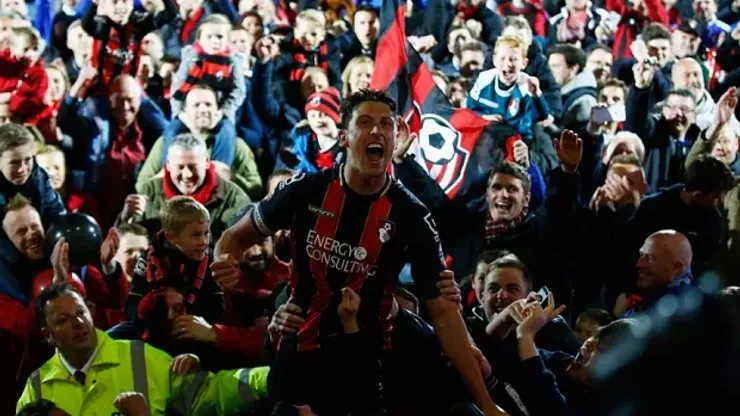 BOURNEMOUTH, ENGLAND – APRIL 27: Captain Tommy Elphick of Bournemouth celebrates victory as fans invade the pitch after the Sky Bet Championship match between AFC Bournemouth and Bolton Wanderers at Goldsands Stadium on April 27, 2015 in Bournemouth, England. (Photo by Clive Rose/Getty Images)
