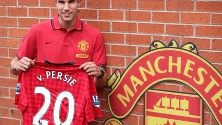 Manchester United's new signing Robin Van Persie poses with his shirt during a photocall at Old Trafford, Manchester.
