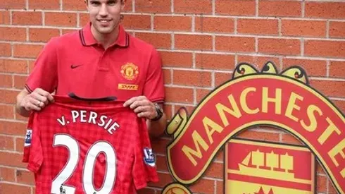 Manchester United's new signing Robin Van Persie poses with his shirt during a photocall at Old Trafford, Manchester.