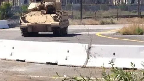 A Bradley Fighting Vehicle from BAE Systems of Santa Clara does a test run on a track next to the San Jose Earthquakes training facility Tuesday after one of the tanks crashed into a concrete barrier 10 feet from where Quakes goalkeeper Jon Busch was training.