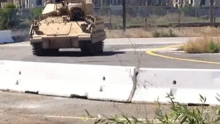 A Bradley Fighting Vehicle from BAE Systems of Santa Clara does a test run on a track next to the San Jose Earthquakes training facility Tuesday after one of the tanks crashed into a concrete barrier 10 feet from where Quakes goalkeeper Jon Busch was training.
