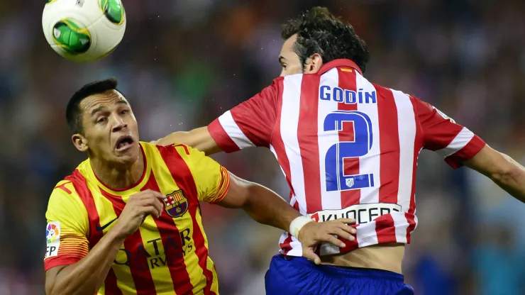 Barcelona's Chilean forward Alexis Sanchez (L) vies with Atletico Madrid's Uruguayan defender Diego Godin during the Spanish Super Cup first leg football match Atletico Madrid vs Barcelona at Vicente Calderon stadium in Madrid on August 21, 2013. AFP PHOTO / JAVIER SORIANO (Photo credit should read JAVIER SORIANO/AFP/Getty Images)
