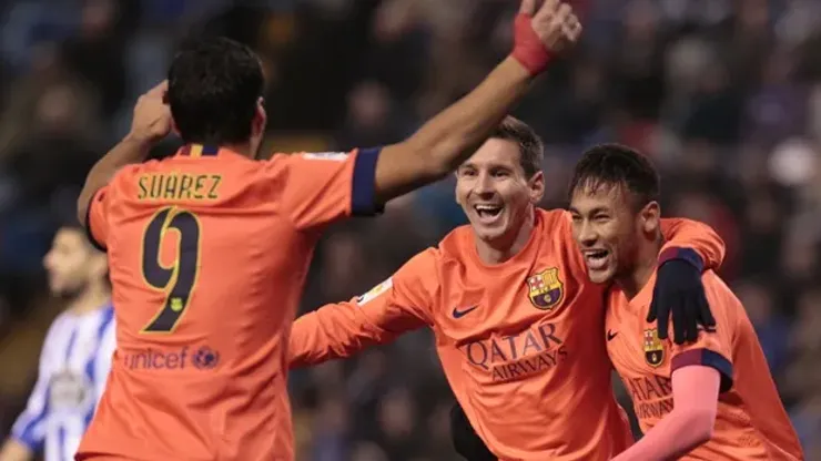 Barcelona's Lionel Messi, center, celebrates after scoring against Deportivo with teammates Neymar, right, and Luis Suarez during a Spanish La Liga soccer match at the Riazor stadium in A Coruna, Spain, Sunday, Jan. 18, 2015. (AP Photo/Lalo R. Villar)
